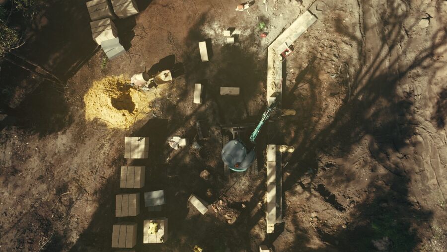 Aerial view of the job site in late afternoon light