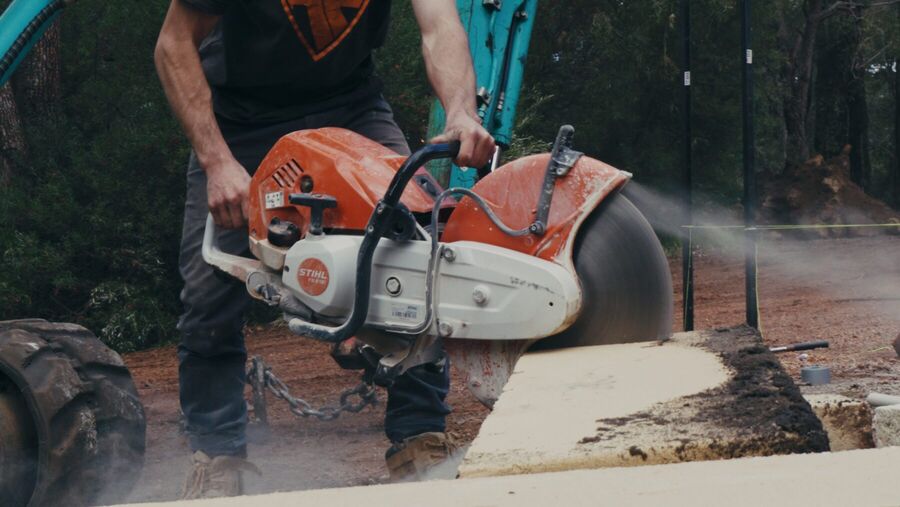 Cutting a limestone block to length on site with a demolition saw